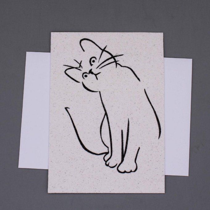 Carte de vœux en sable représentant un chat stylisé aux lignes noires minimalistes.