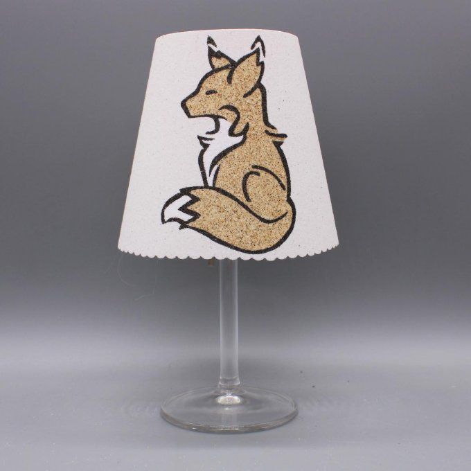 Photophore artisanal « Renard » représentant un renard en sable noir et naturel sur fond blanc.
